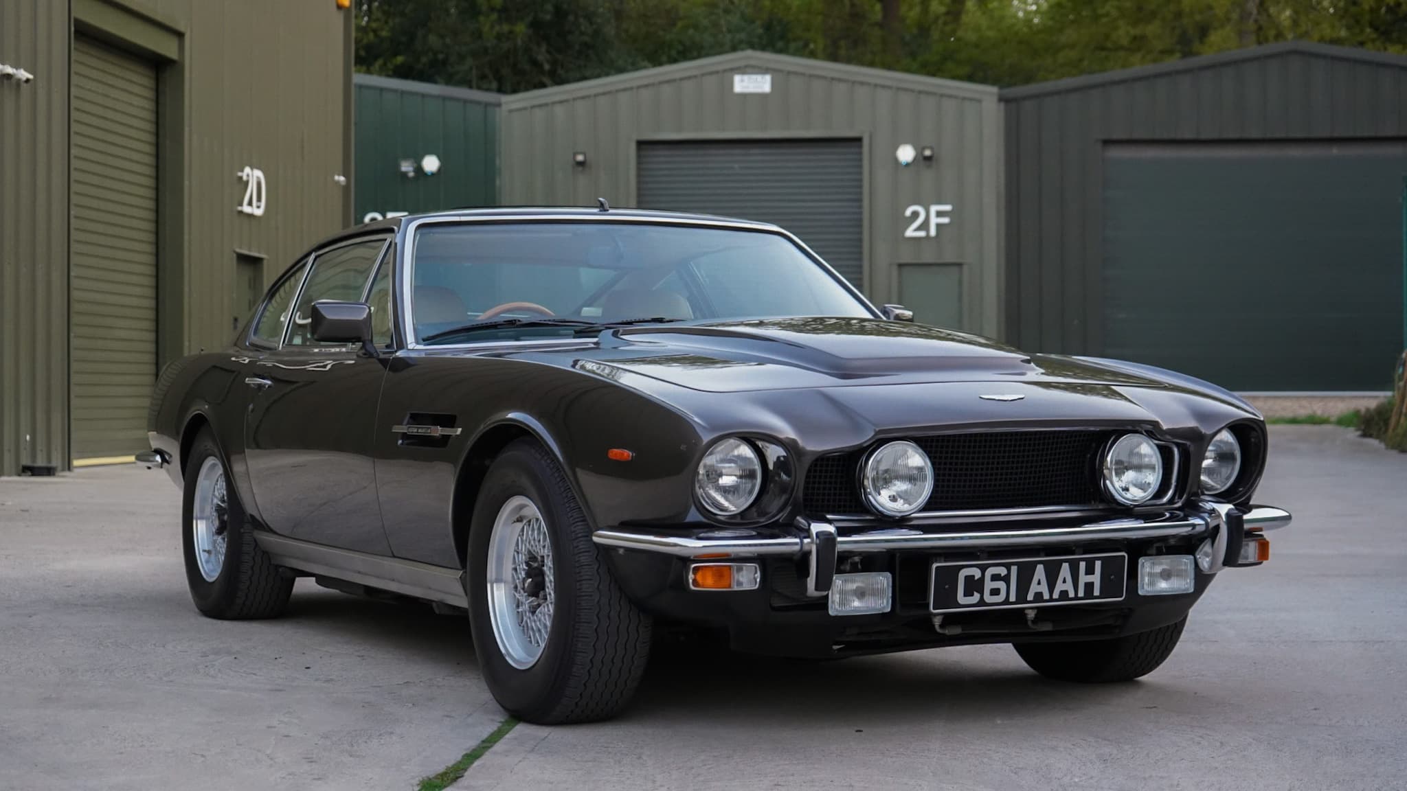 Dark brown 1985 Aston Martin V8 Saloon Series 4 “Oscar India” in a front three-quarter view.