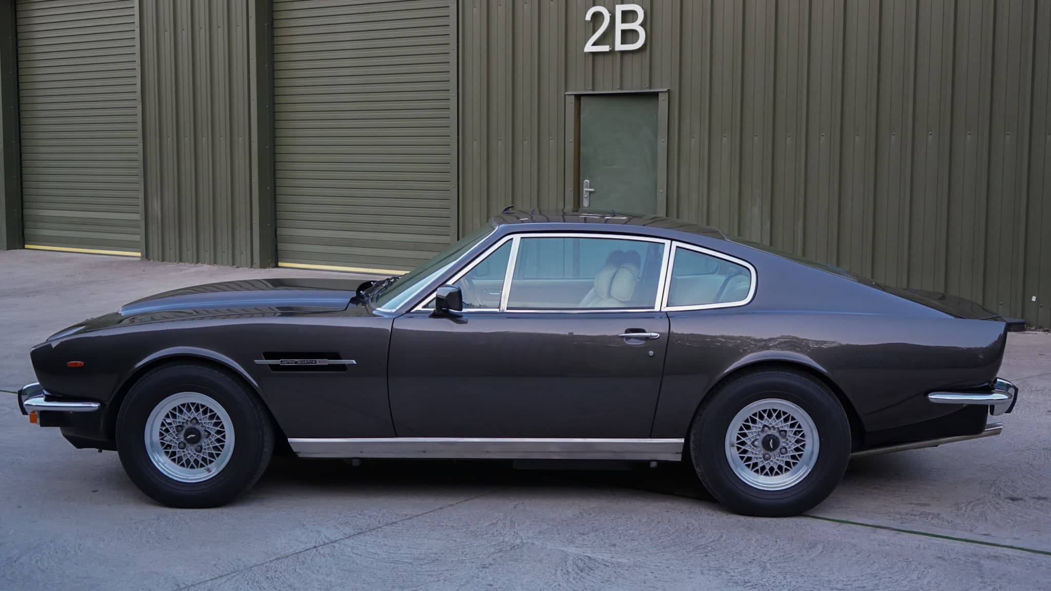 Dark brown 1985 Aston Martin V8 Saloon Series 4 “Oscar India” in a side profile.
