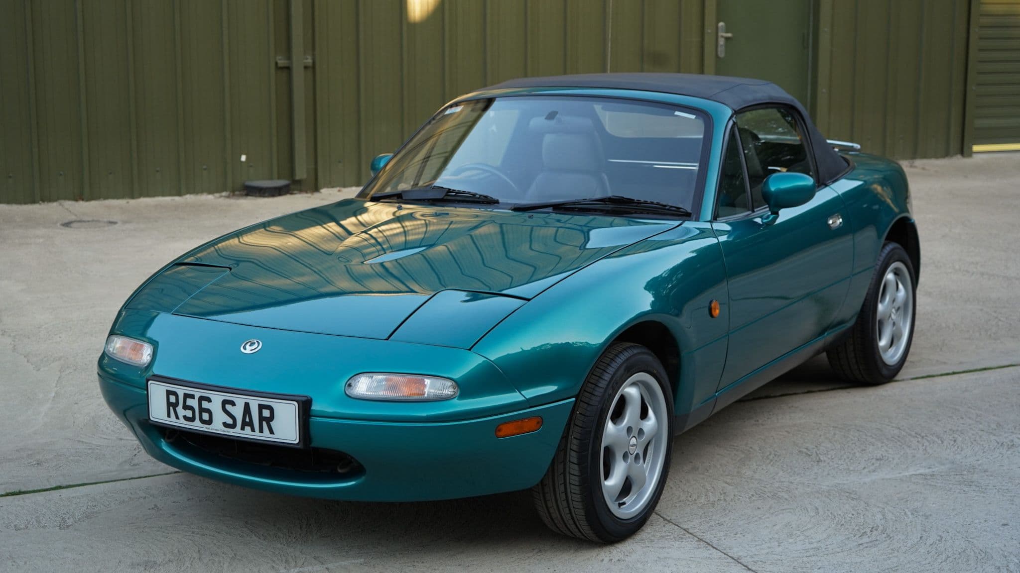 Green 1998 Mazda MX-5 Berkeley Edition in a close front three-quarter view.
