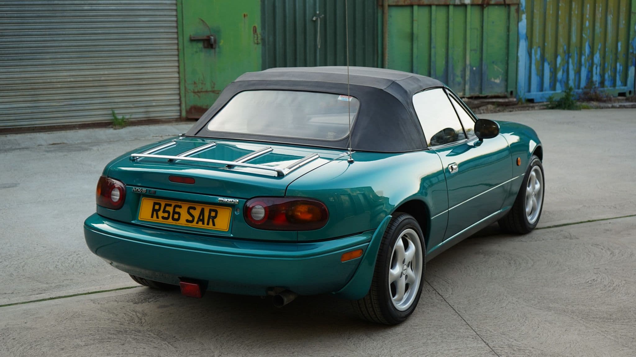 Green 1998 Mazda MX-5 Berkeley Edition in a rear three-quarter view.