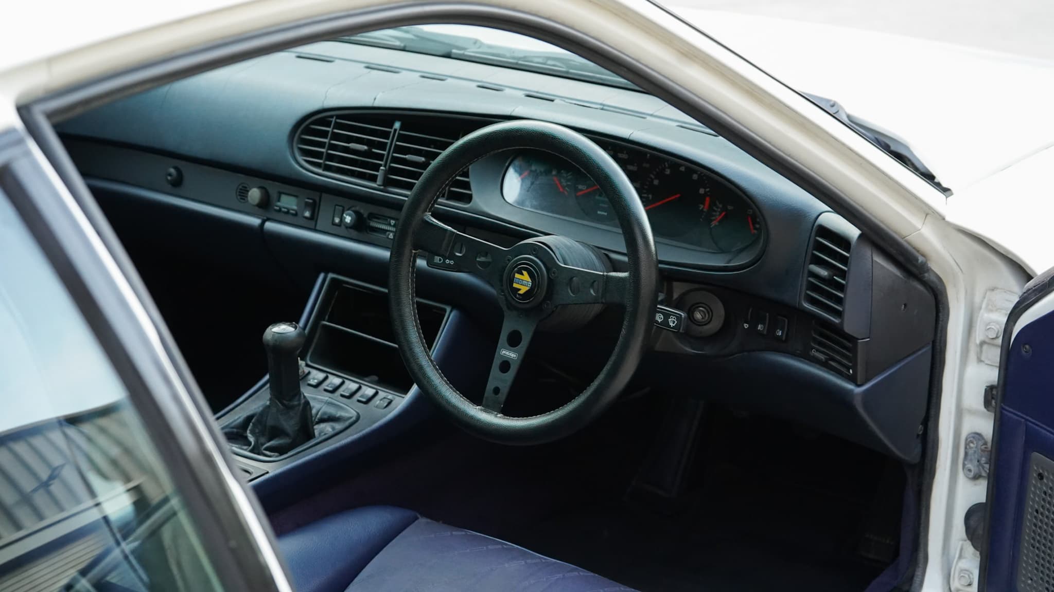 Porsche 944 S2 3.0L interior showing the steering wheel and dashboard.