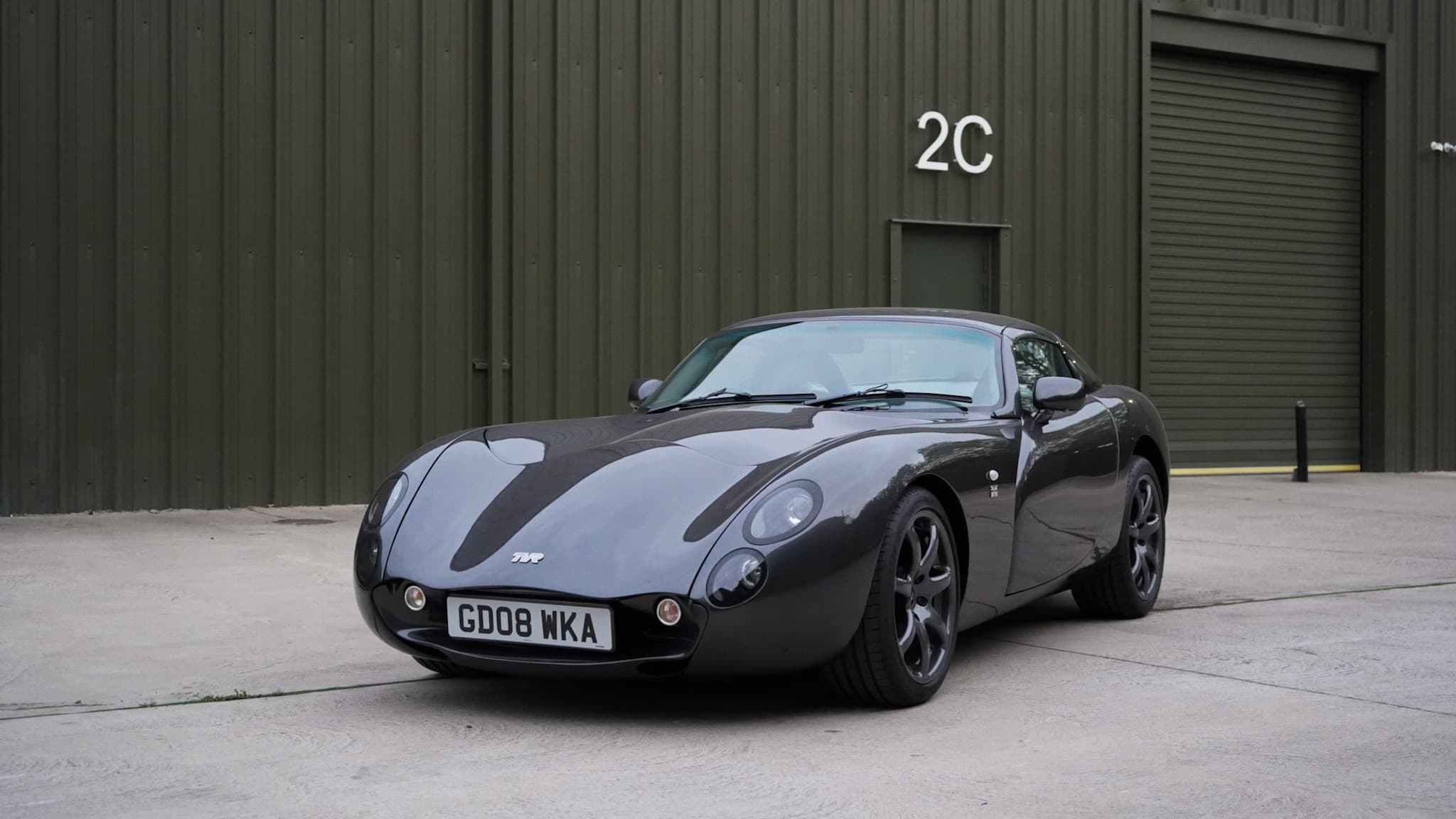 Dark grey TVR Tuscan Mk3 in a wide front three-quarter view.