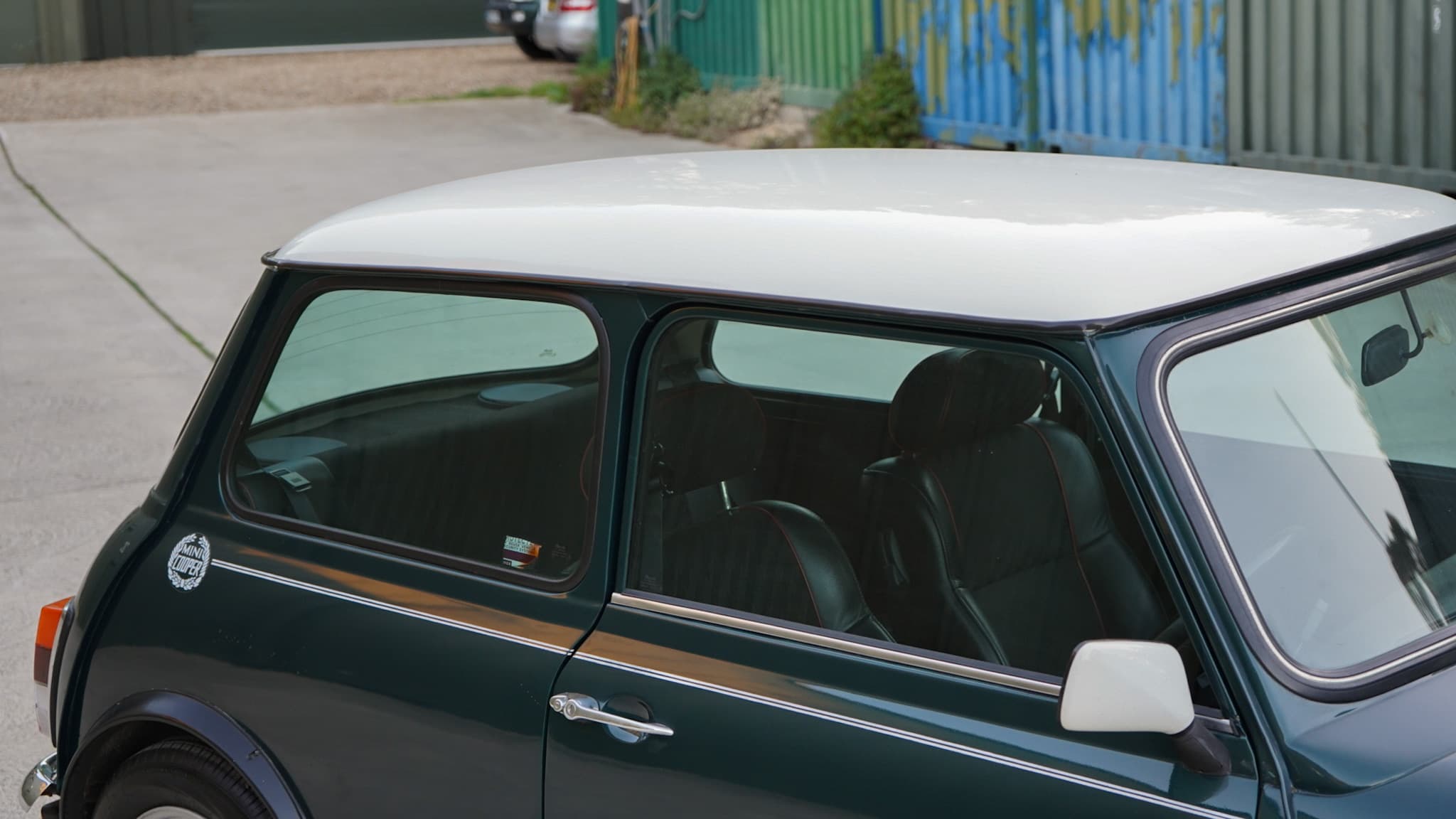Dark green with white roof 1993 Rover Mini Automatic showing the roof and side window detail.