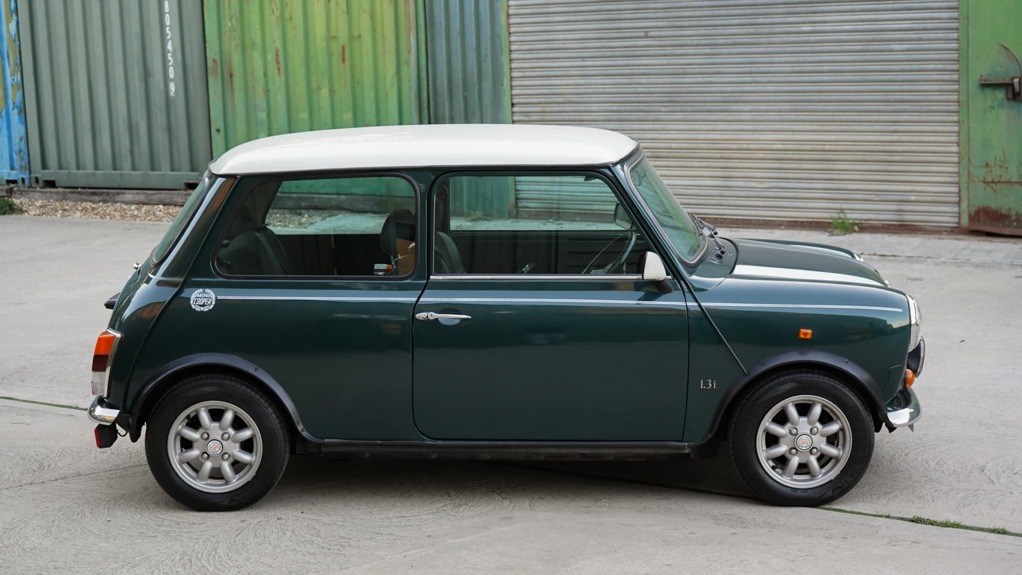 Dark green with white roof 1993 Rover Mini Automatic in a side profile.