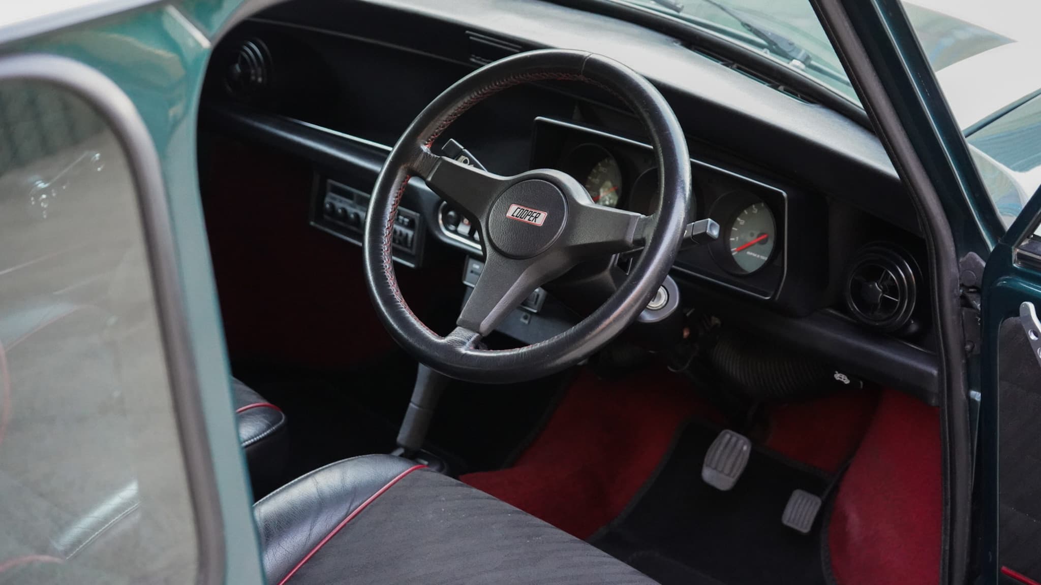 1993 Rover Mini Automatic interior showing the steering wheel dashboard and driver footwell.