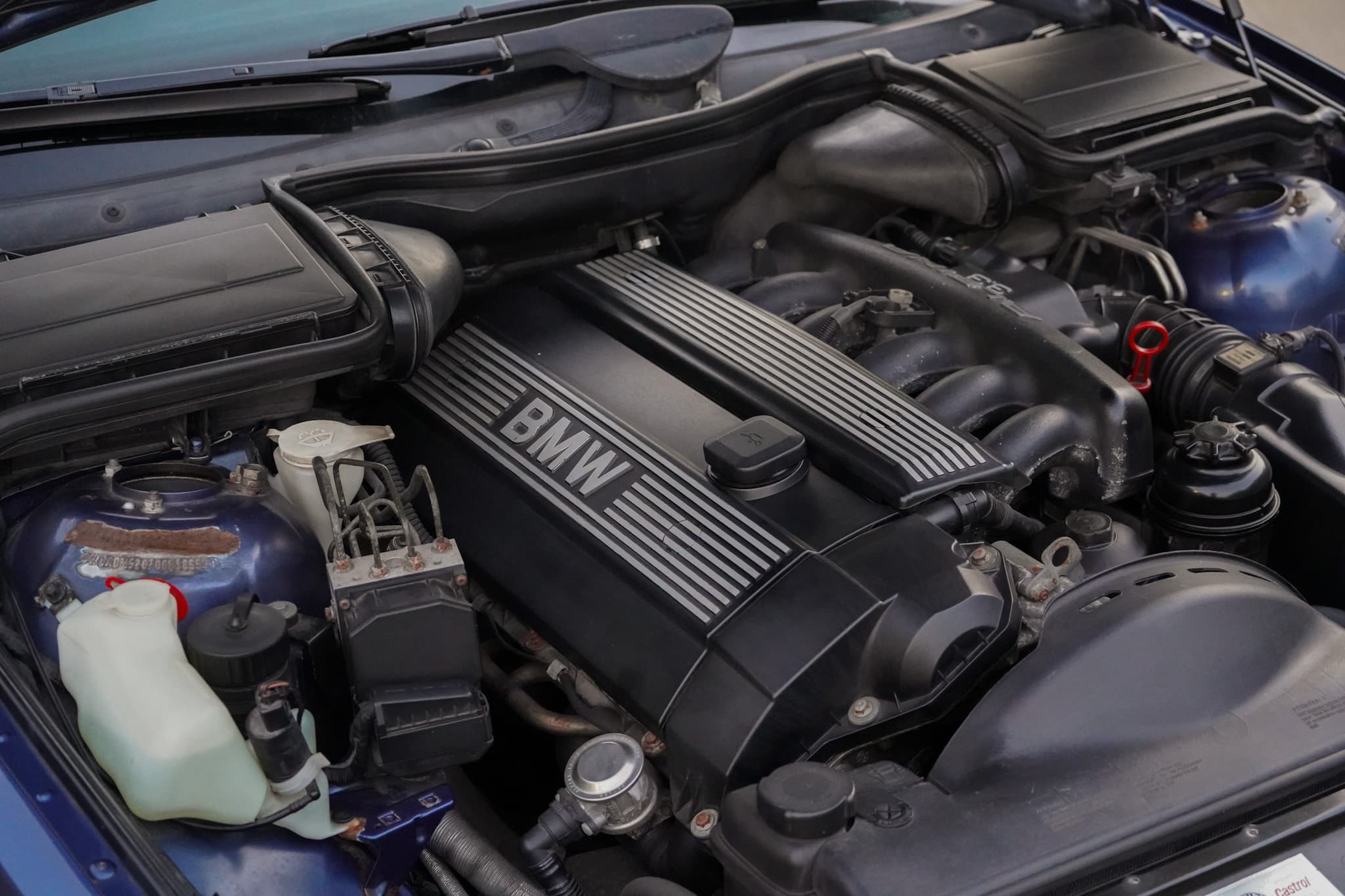 Blue 1999 BMW E39 Alpina B10 3.3 Manual showing the engine bay top view.