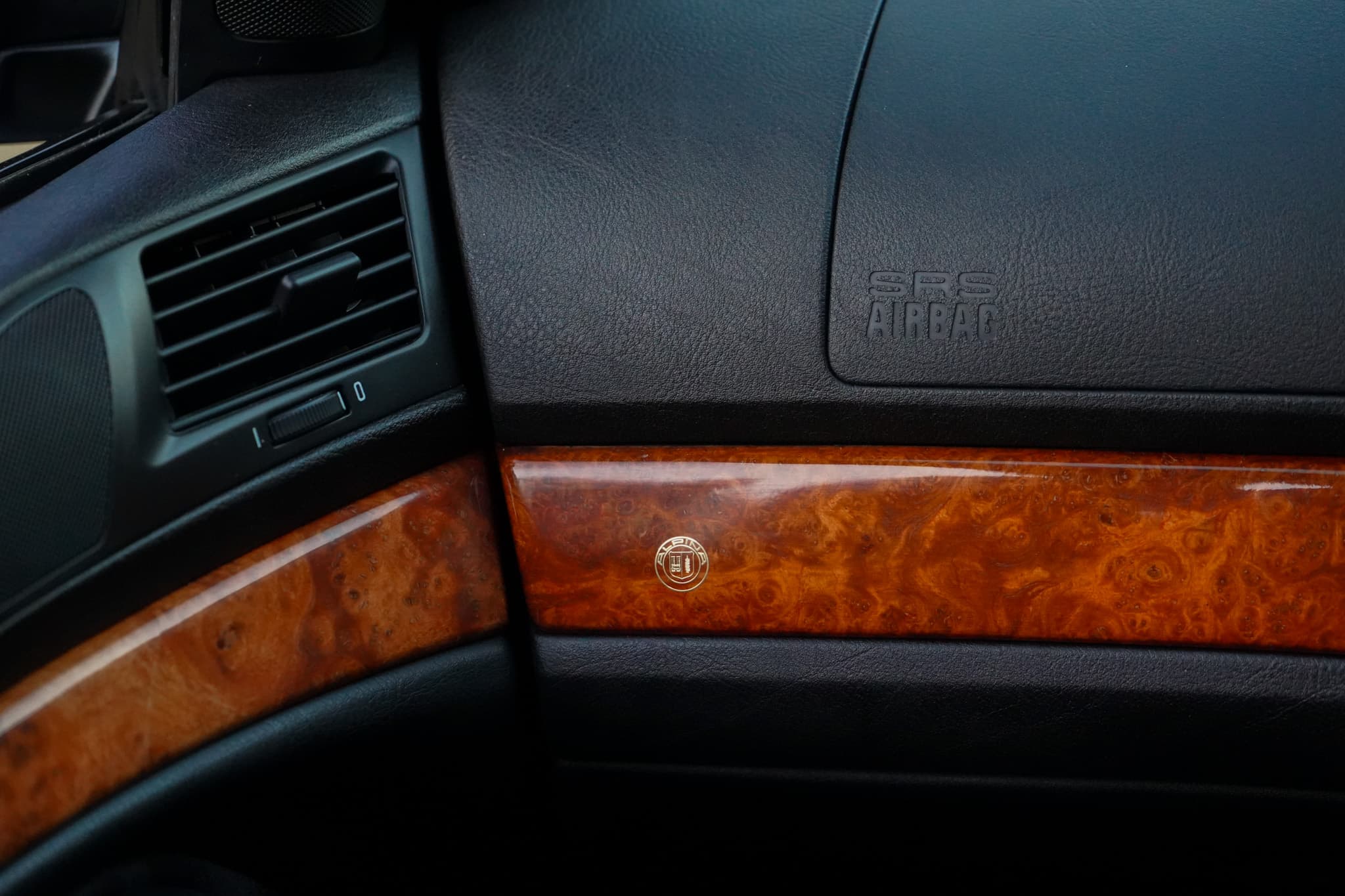 1999 BMW E39 Alpina B10 3.3 Manual interior showing the passenger dashboard wood trim.