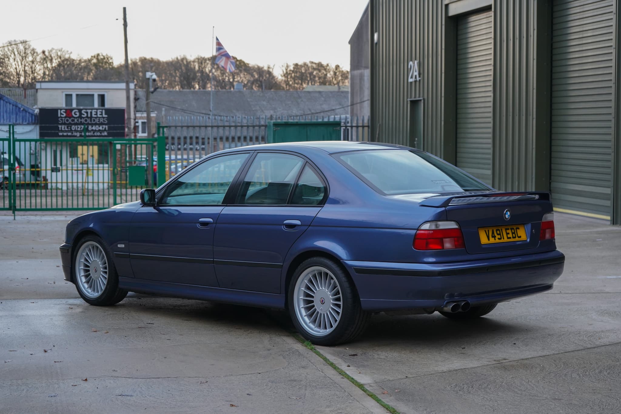 Blue 1999 BMW E39 Alpina B10 3.3 Manual in a wide rear three-quarter view.