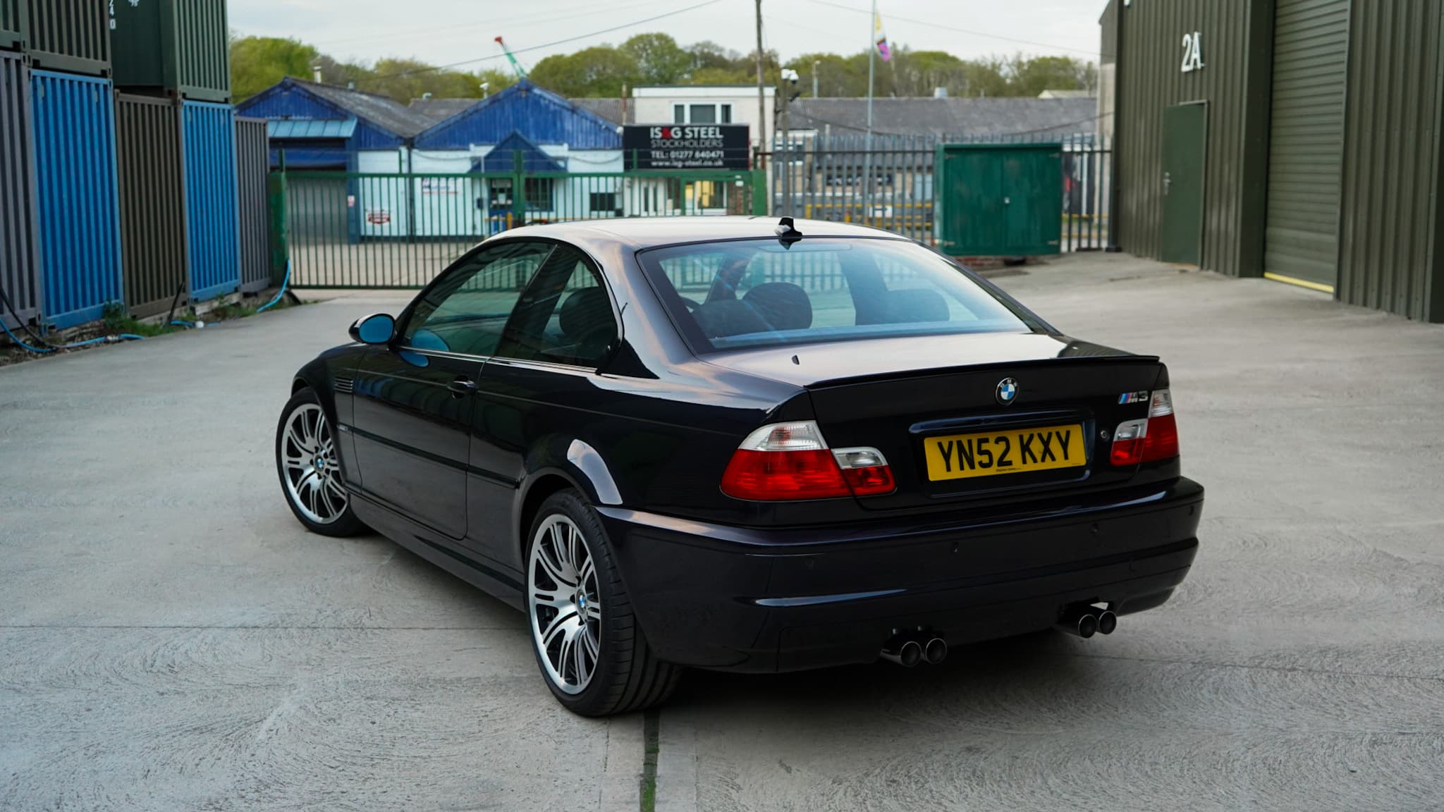 Black 2002 BMW M3 (E46) Manual in a wide rear three-quarter view.