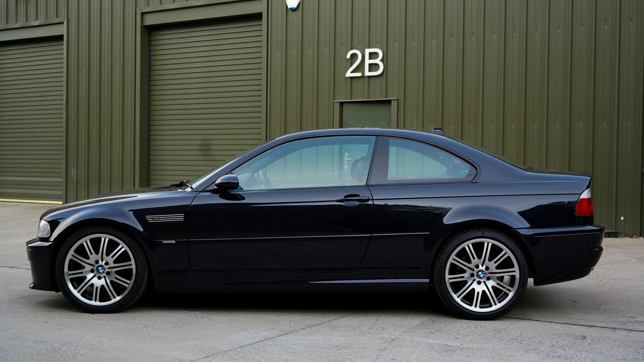 Black 2002 BMW M3 (E46) Manual in a side profile.