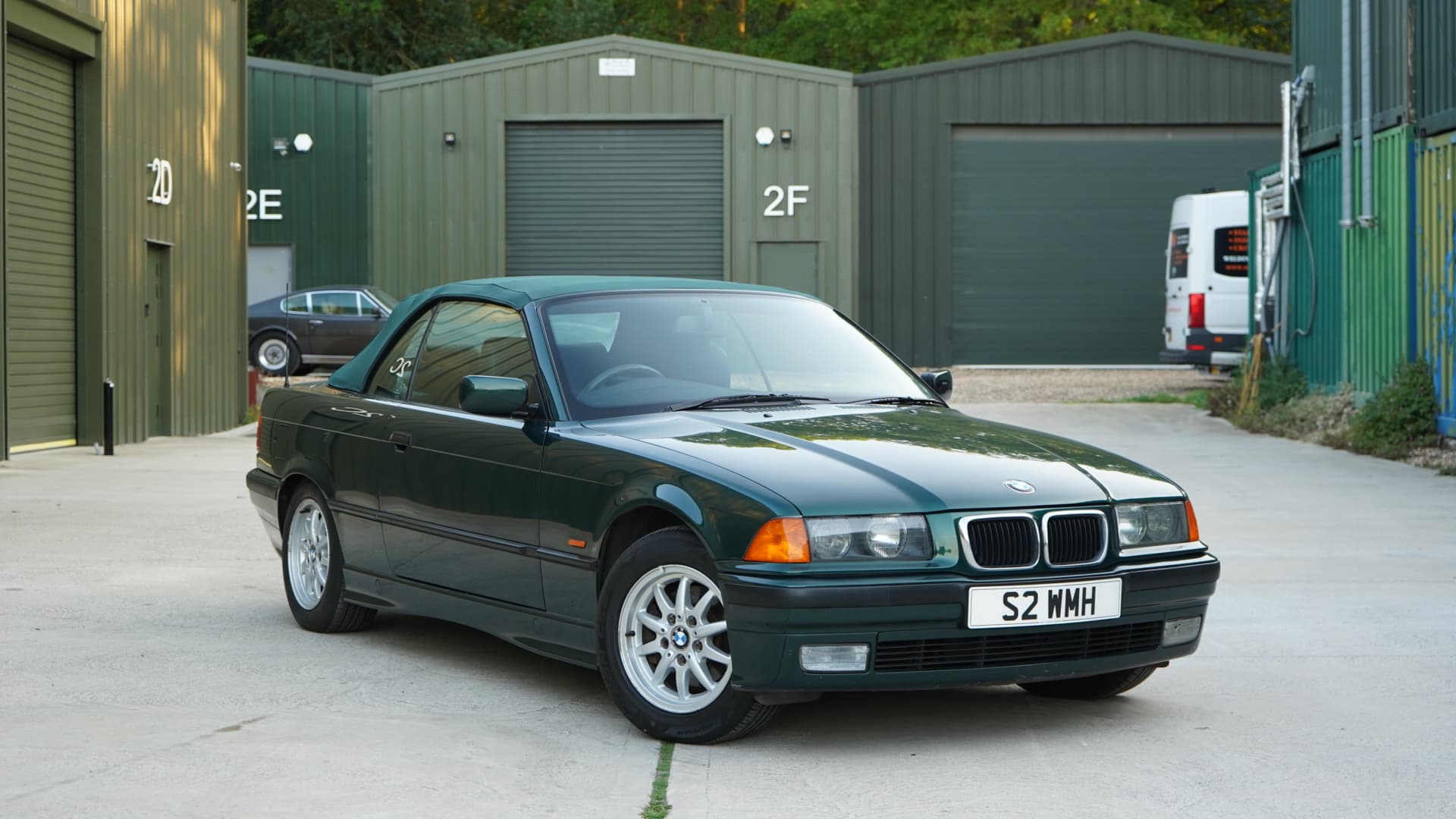 Dark green BMW 328i (E36) Manual Convertible in a front three-quarter view.