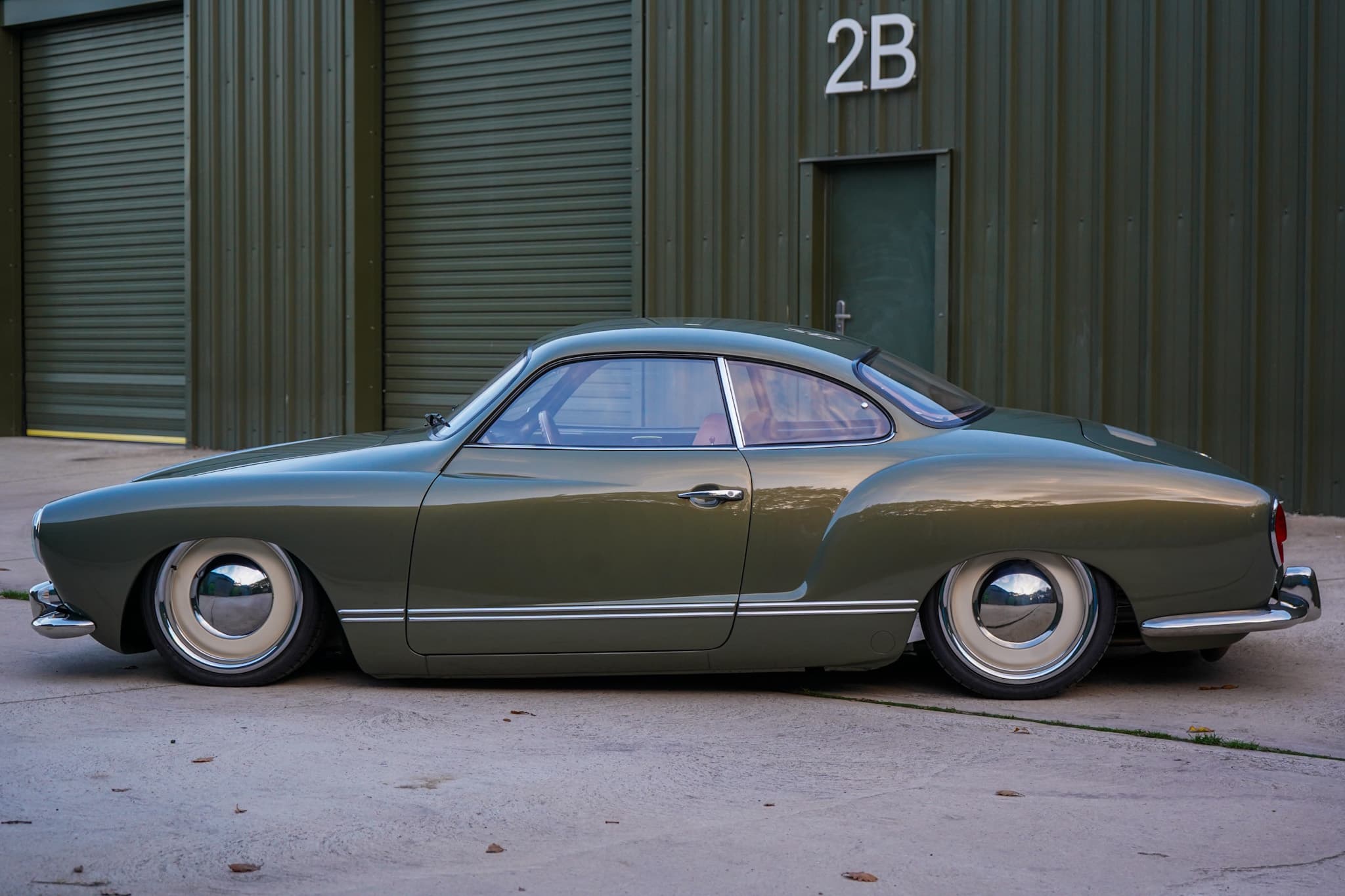 Green Volkswagen Karmann Ghia Type 14 Restomod in a side profile.