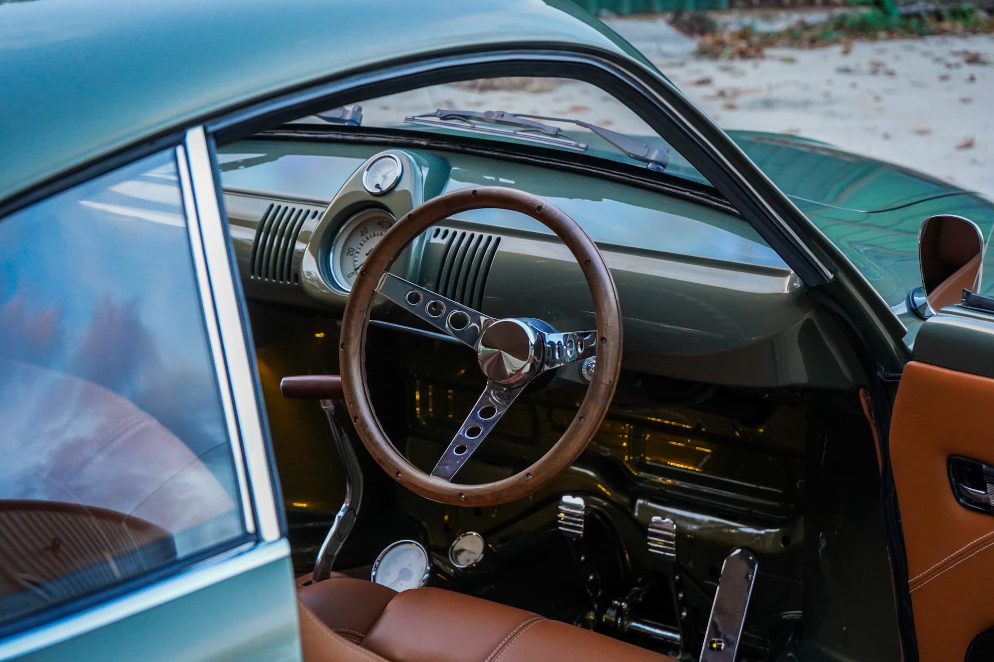 Volkswagen Karmann Ghia Type 14 Restomod interior showing the steering wheel dashboard and driver footwell.