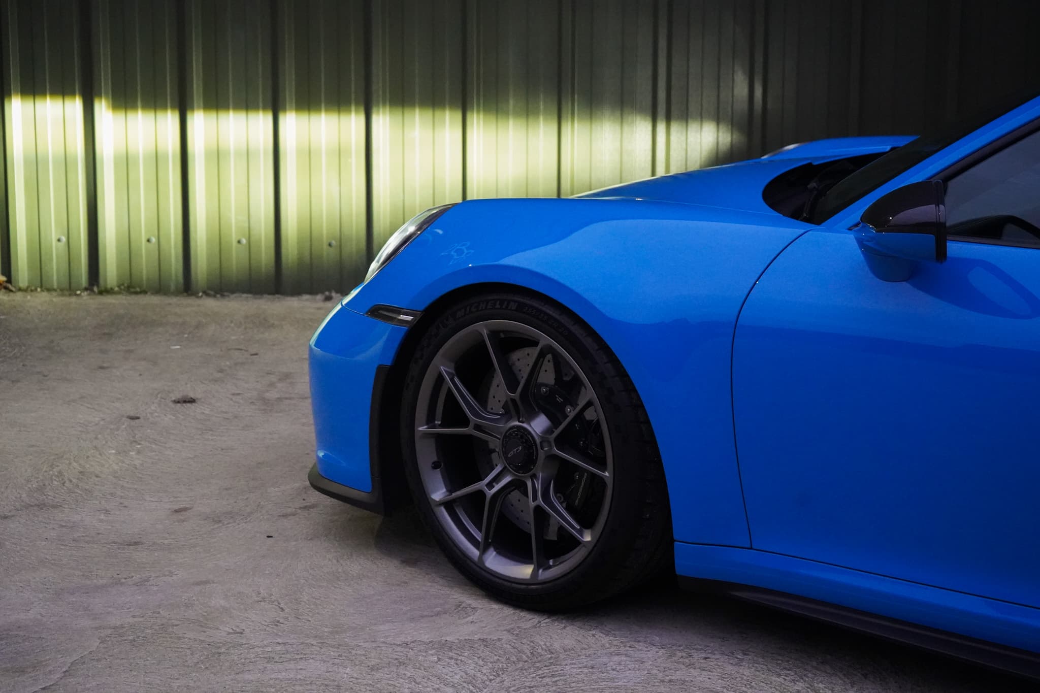 2022 Porsche 911 (992) GT3 showing the front wheel and headlight side detail.