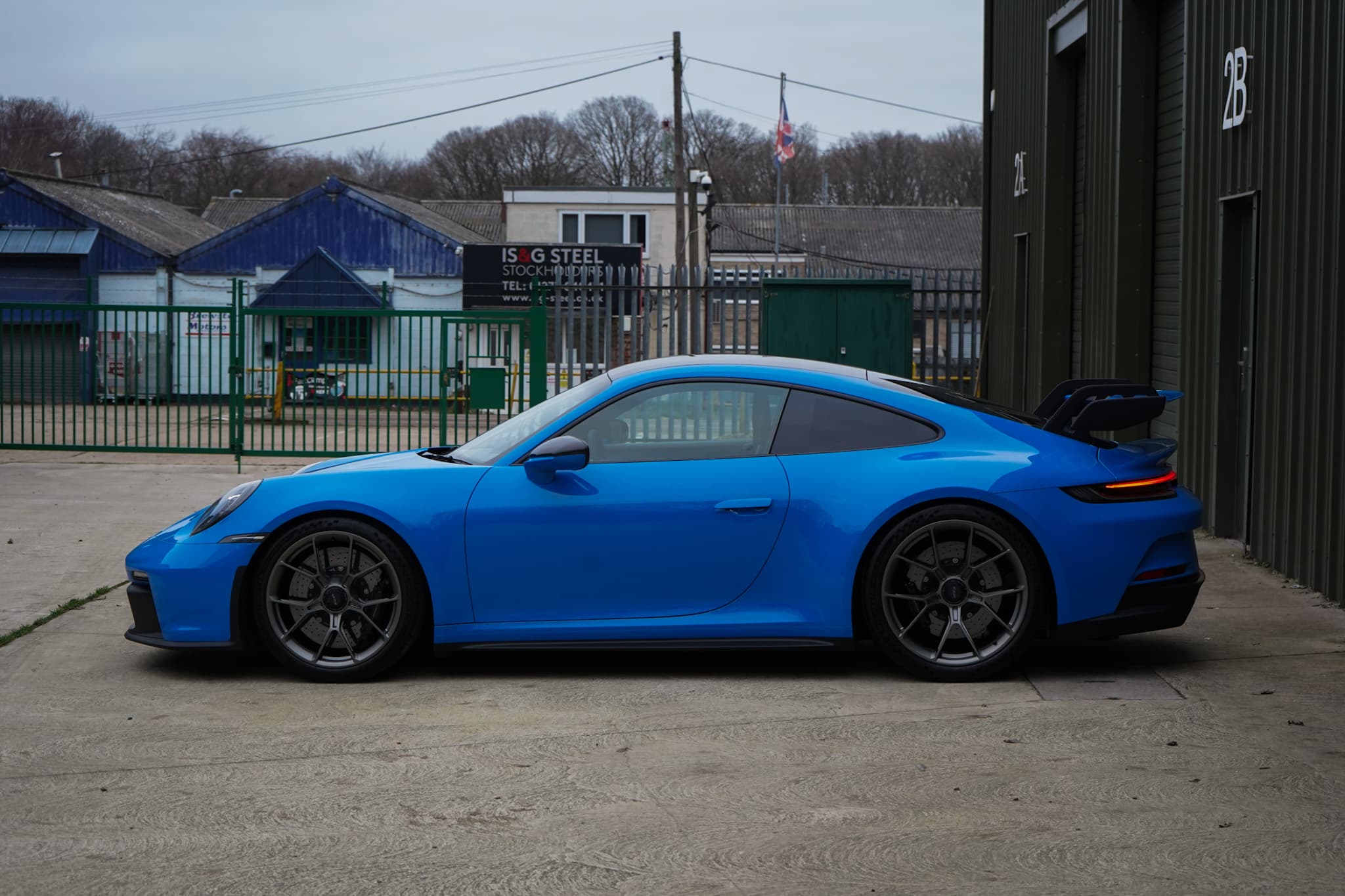 Shark Blue 2022 Porsche 911 (992) GT3 in a side profile.
