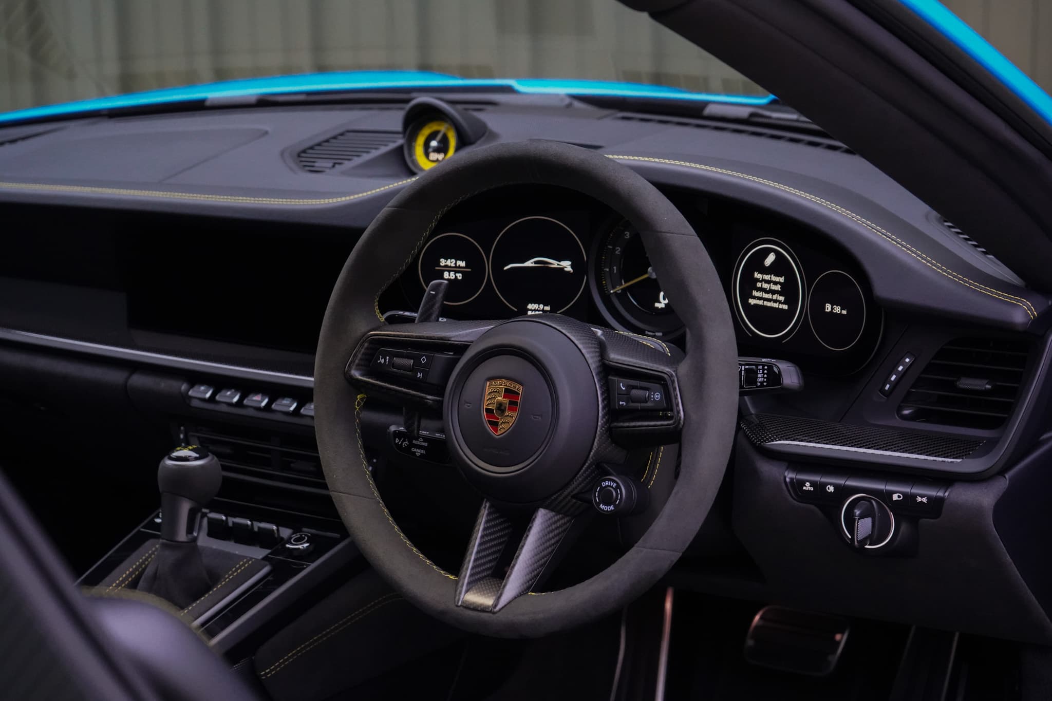 2022 Porsche 911 (992) GT3 interior showing the steering wheel dashboard and instrument cluster.