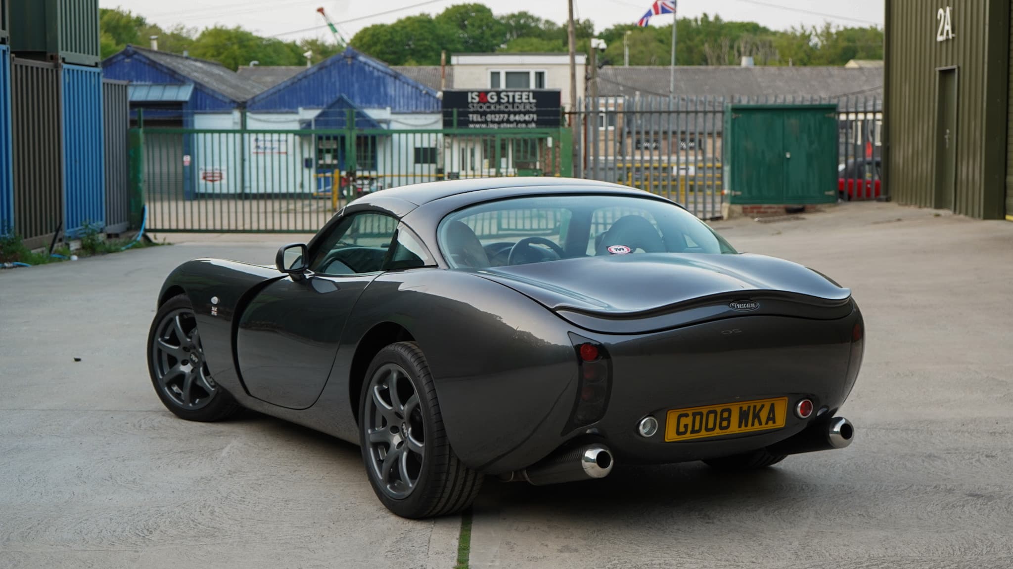 Dark grey TVR Tuscan Mk3 in a wide rear three-quarter view.