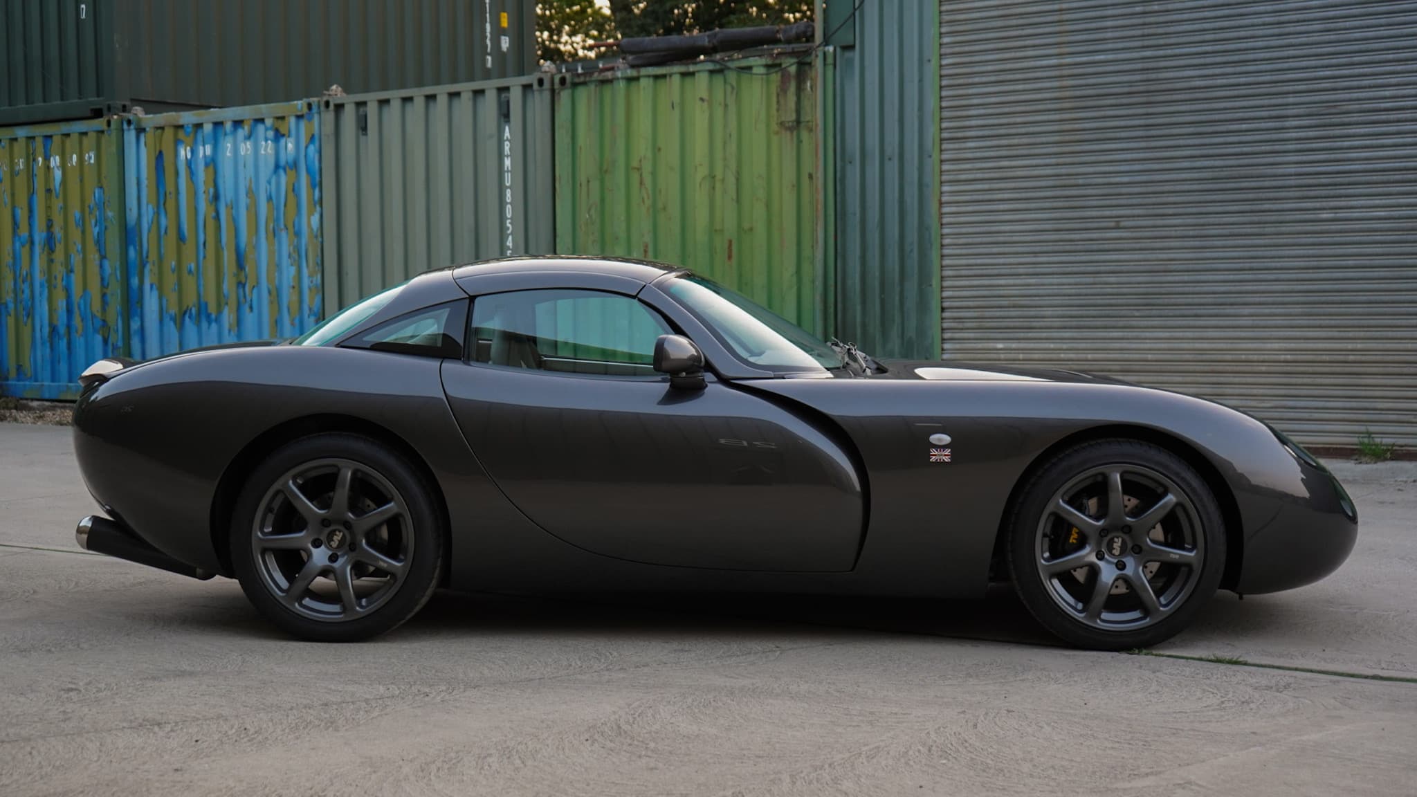 Dark grey TVR Tuscan Mk3 in a side profile.