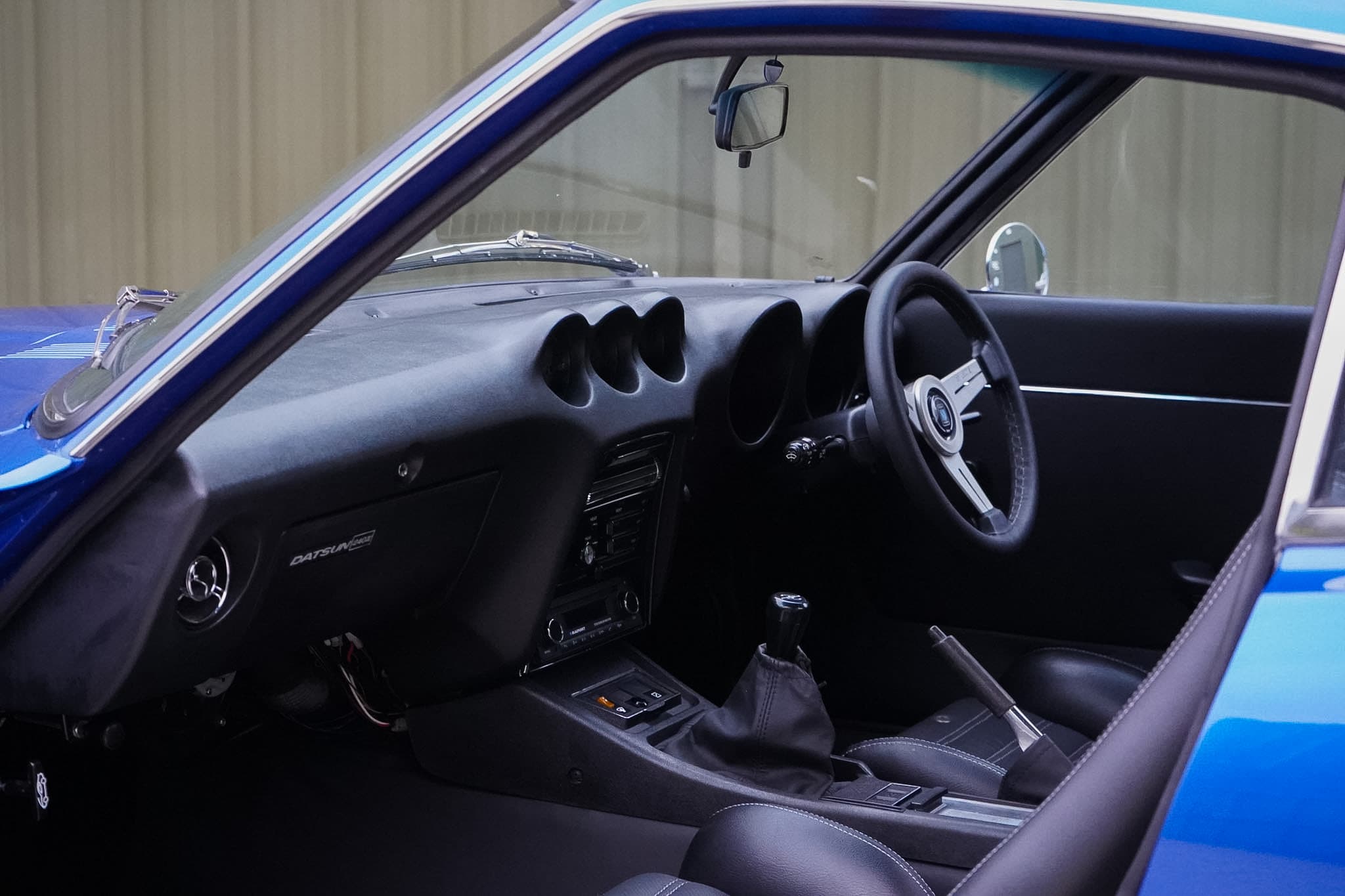 Datsun 240Z Restomod dashboard and steering wheel view.