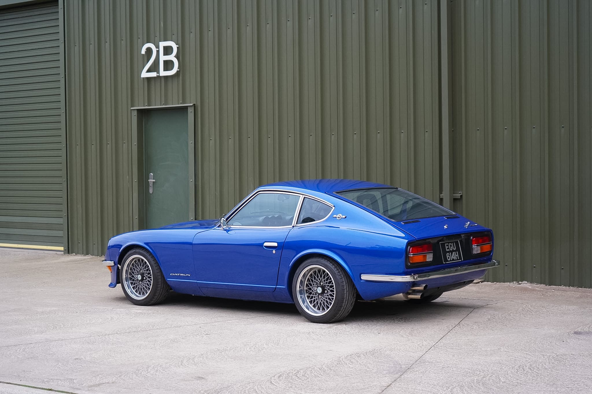 Blue Datsun 240Z Restomod rear three-quarter view.