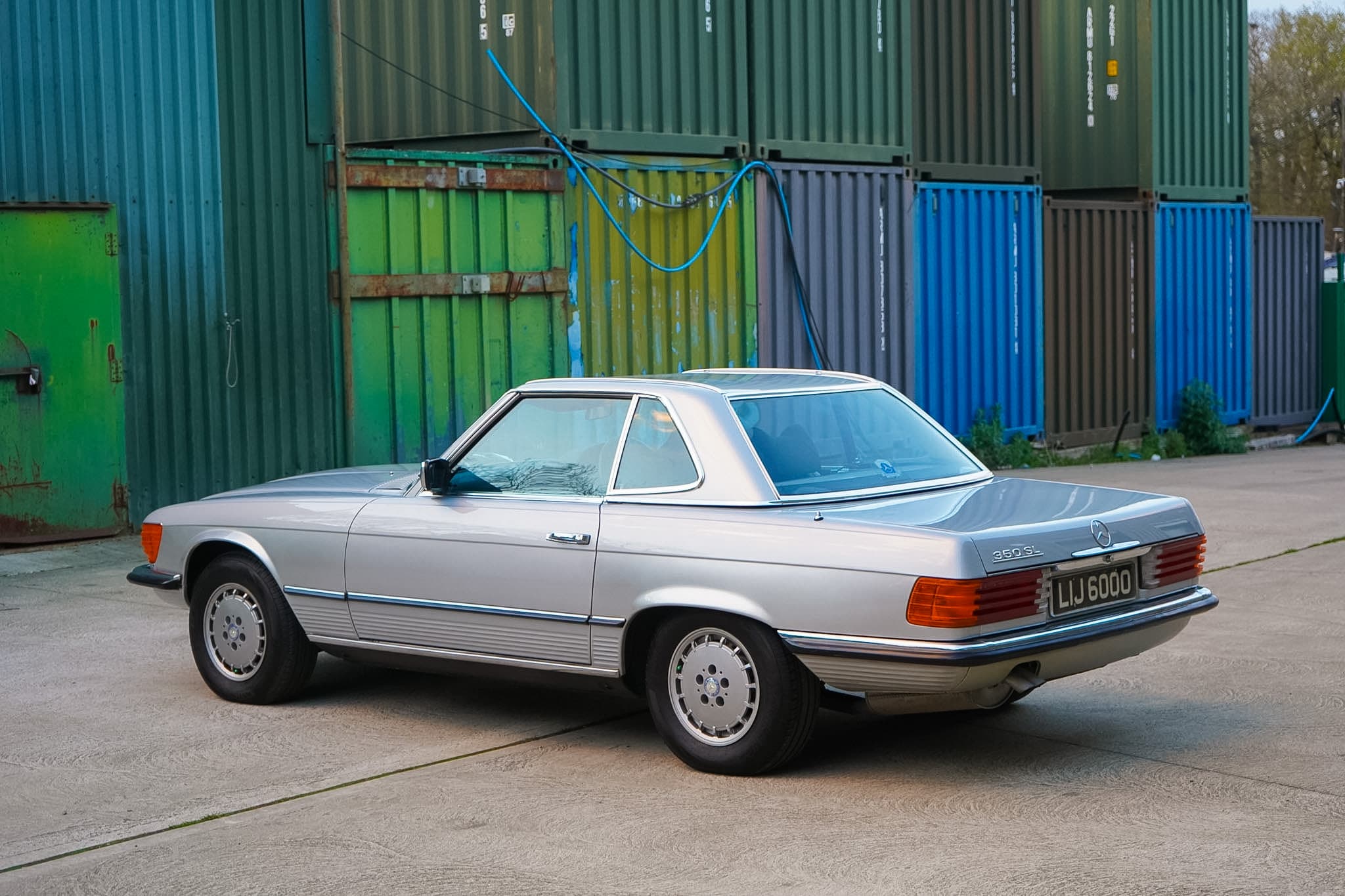 Silver Mercedes-Benz 350 SL (R107) rear three-quarter view with hardtop fitted.