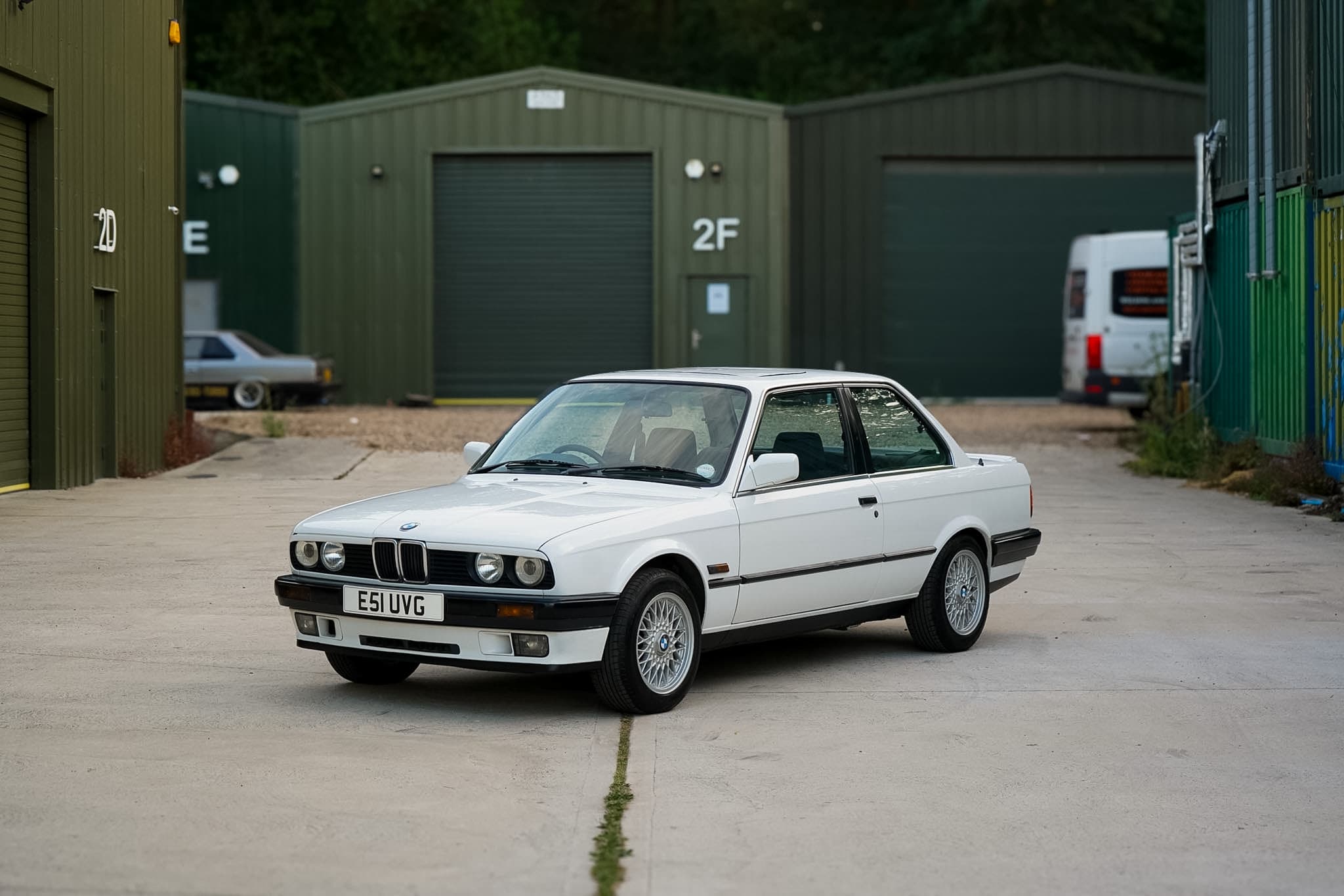 White BMW 325i (E30) Manual Coupe front three-quarter view.