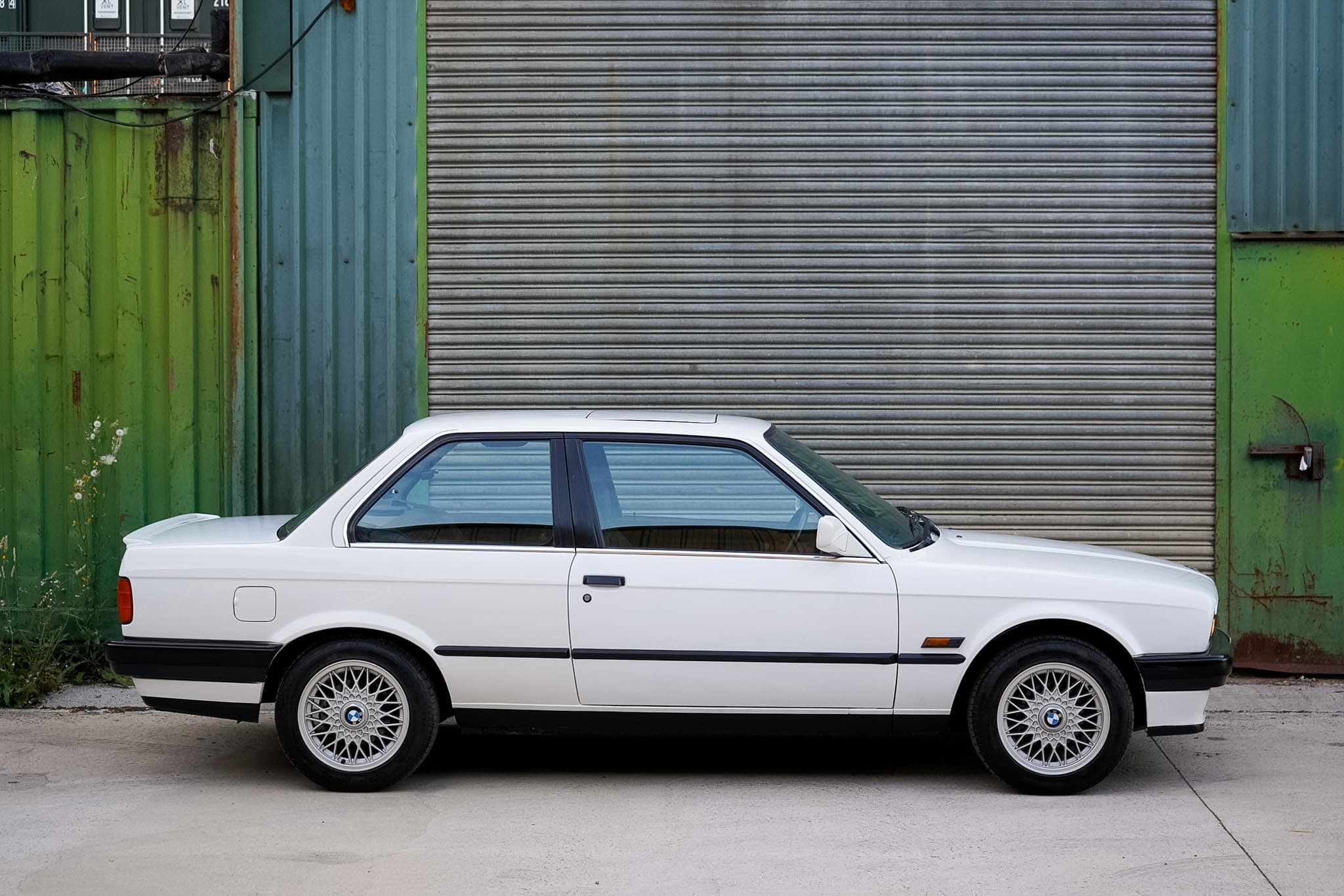 White BMW 325i (E30) Manual Coupe full side profile.