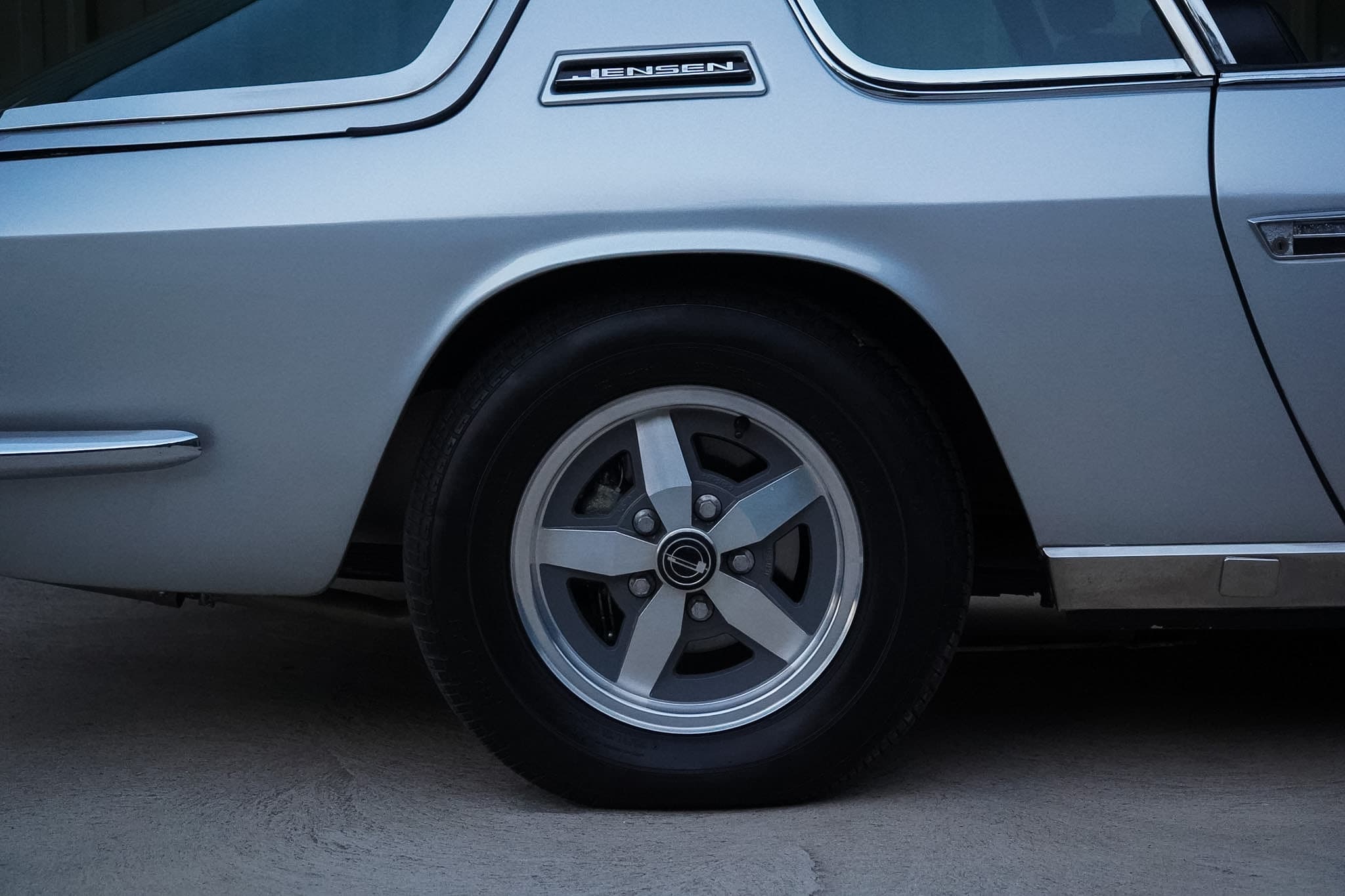 Silver Jensen Interceptor Mk III rear wheel and quarter-panel detail.